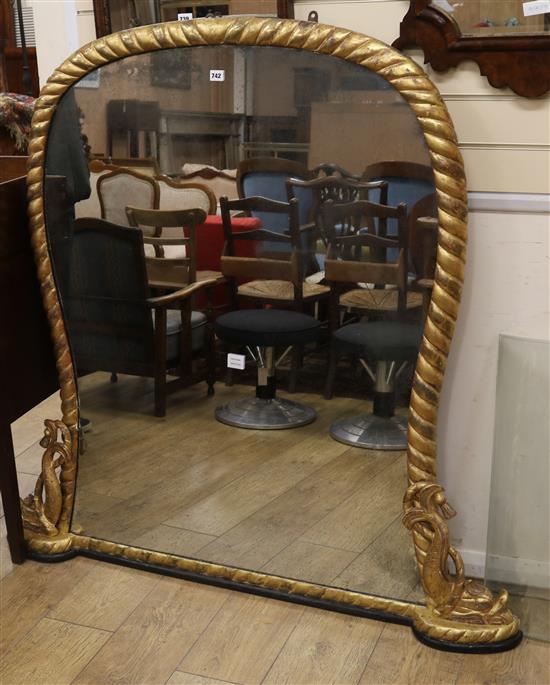 An early Victorian giltwood framed overmantel, carved with gadrooning, the base flanked by dolphins, W.135cm